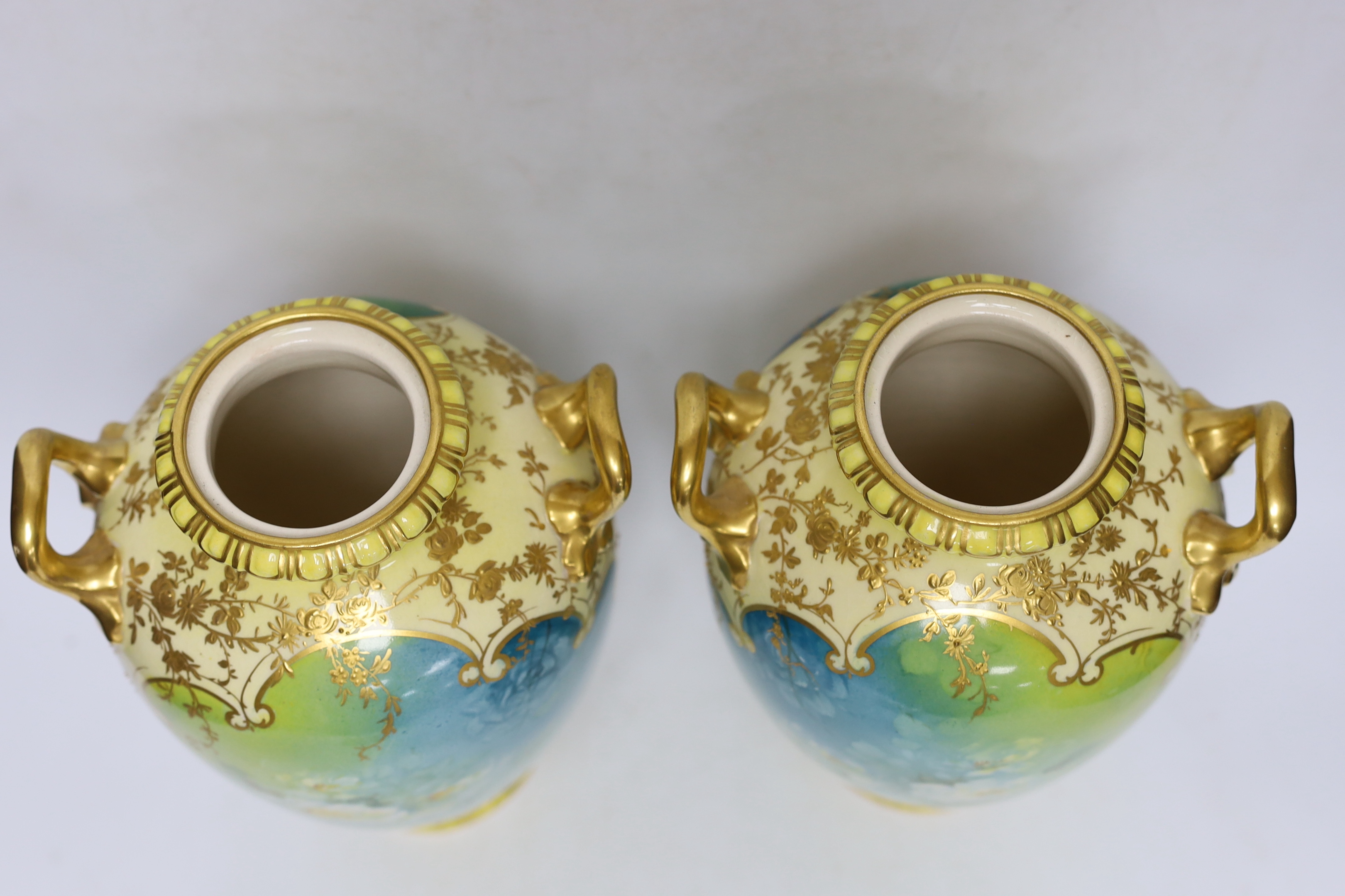A pair of Royal Bonn flower painted earthenware vases and covers, 34cm